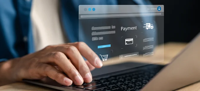 A close up of a man typing on a keyboard with a virtual screen displaying a payment form hovering above the keyboard